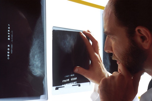 a man looking at an x-ray