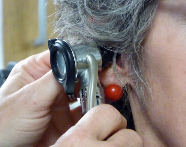 a doctor checking a person’s ear