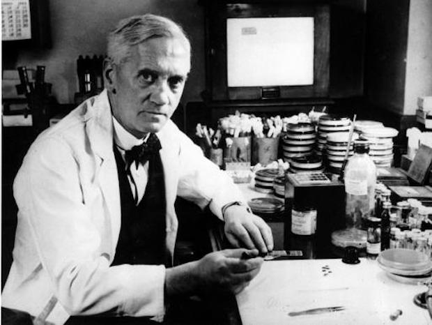 A black and white photo of Alexander Fleming with scientific equipment