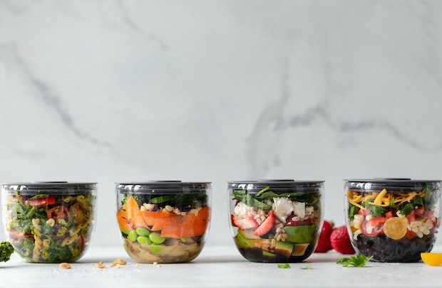 prepared food containers filled with salad