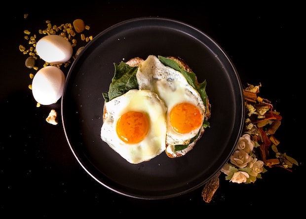 toast topped with spinach greens and eggs