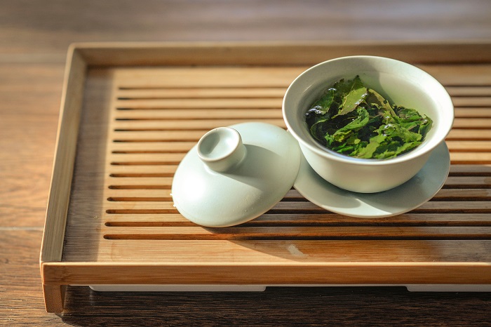 Green tea leaves steeping in cup