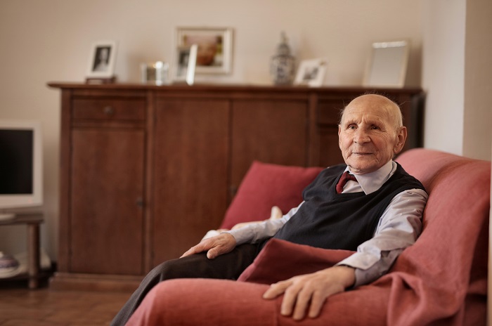elderly man sitting on a couch