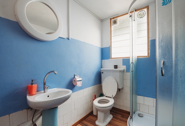 a bathroom with blue and white walls