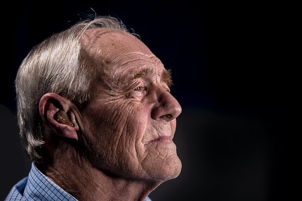 an old man with a hearing aid